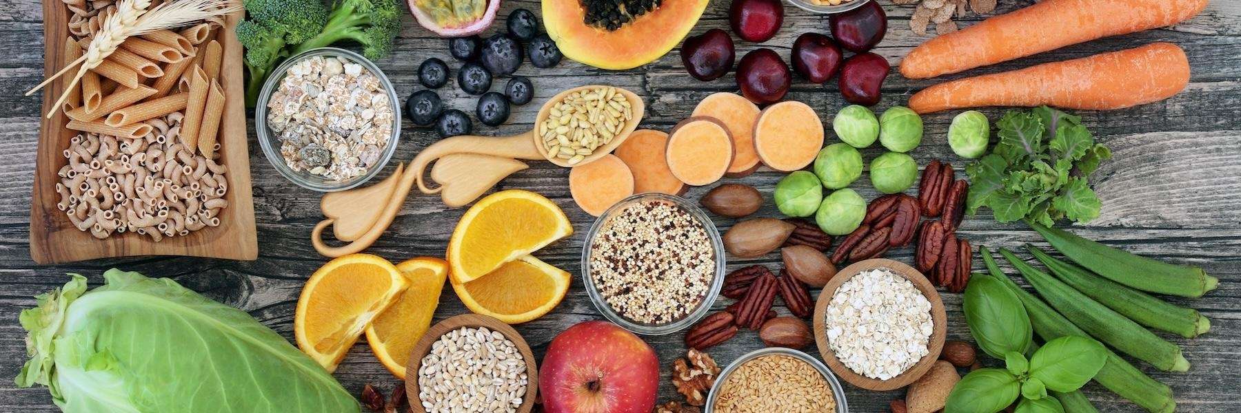 An assortment of healthy foods arranged on a rustic wooden surface.